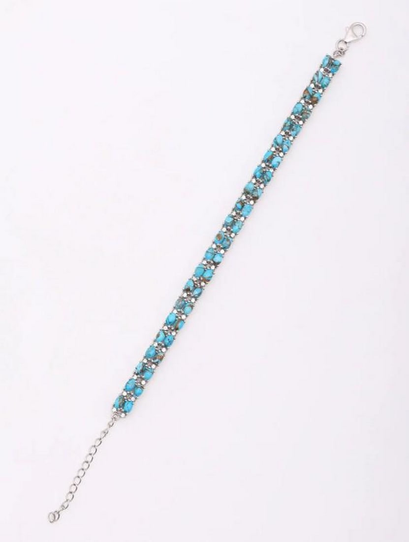 Tibetan Turquoise Sterling Silver Tennis Bracelet: Tibetan Turquoise Sterling Silver Tennis Bracelet A captivating twist on a classic design, this tennis bracelet features polished Tibetan turquoise cabochons set in sterling silver. The vivid blue-gre