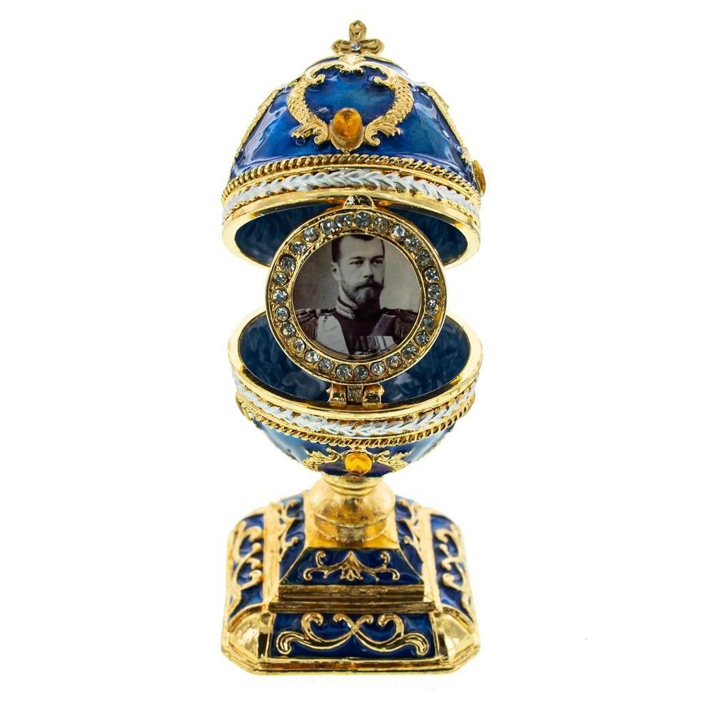 Regal Inspired Blue Scrolls Easter Egg: Regal Inspired Blue Scrolls Easter Egg This hand-painted, gold-plated pewter egg features high-polished enamel with golden trim and is adorned with Austrian crystals. Openable on a hinge, it secures