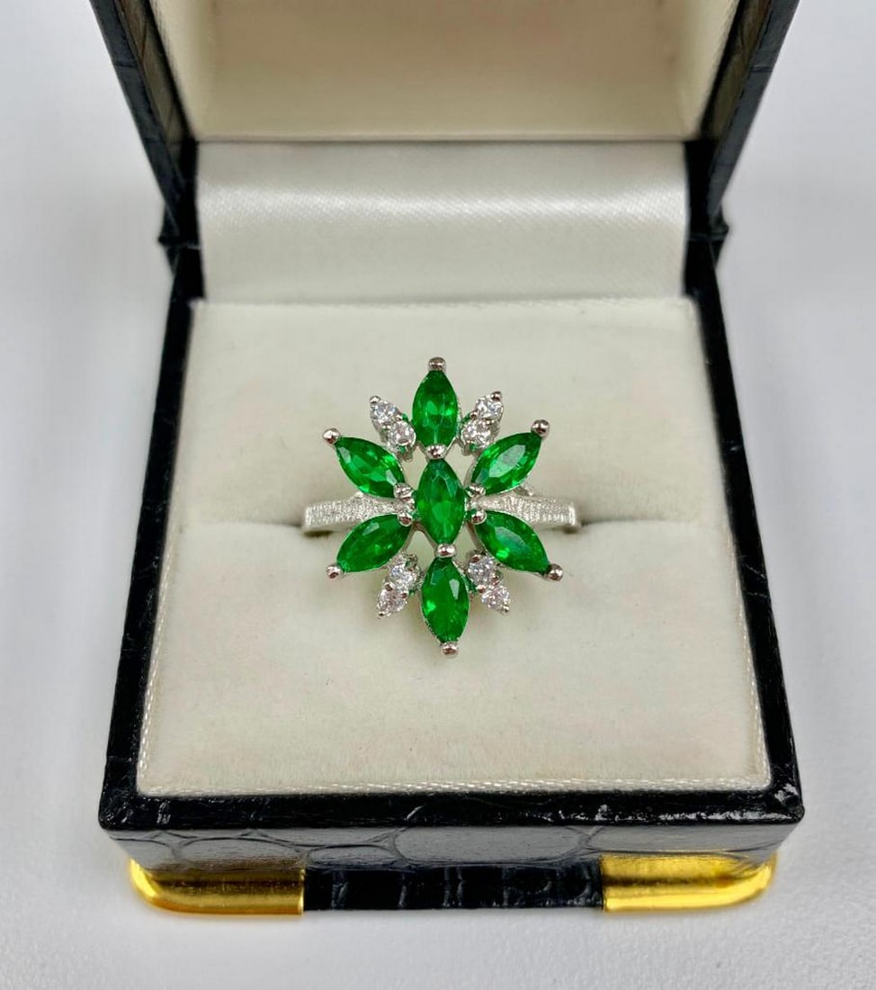 Lovely Ladies Size 7 Green Tourmaline and Sterling Silver Ring: A symmetrically designed ring, with Seven 0.18ct Marquise cut green Tourmaline Stones. Bordered by eight round cut crystals. all set in a sleek 925 Sterling Silver ring. Please view photos for further