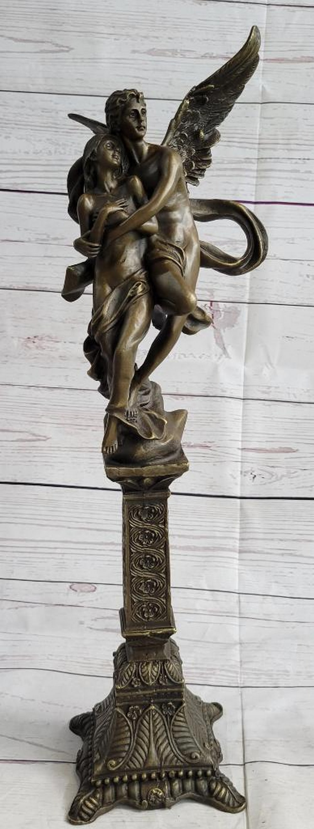 19'' Tall Nude Male Angel Carries Girl Mythical Deco Bronze Sculpture Art Nouveau: A nude male angel carries a nude girl and in his arms. The girl clutches her bare chest as she head tilts up to her lover and protector. They are almost nude with only a cloth lightly draped over the