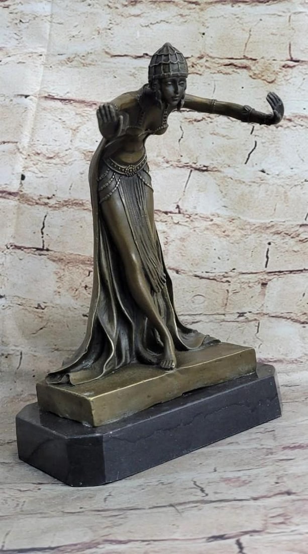 Egyptian Princess Bronze Sculpture: Egyptian Princess Bronze Sculpture This Egyptian princess bows graciously with her hands out to her side as her long royal flowing dress cascades down her legs and gathers at her feet. On her head she