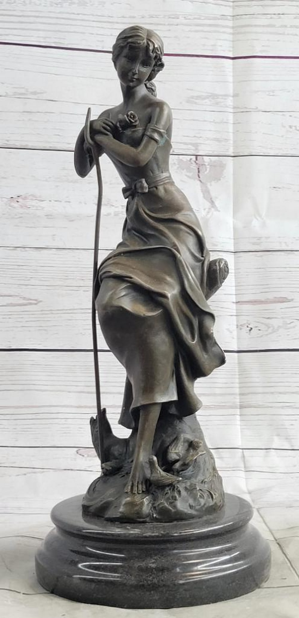 Art Nouveau Maiden with Rose Bronze Sculpture – 14" x 6": Art Nouveau Maiden with Rose Bronze Sculpture – 14" x 6" This Art Nouveau bronze depicts a graceful maiden standing in a flower garden, delicately holding a rose. Her flowing off-shoulder dr