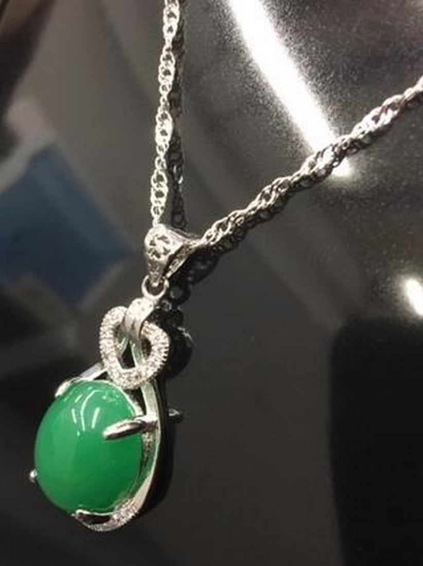 Jade Serenity Pendant Necklace: Jade Serenity Pendant Necklace Elevate your look with this elegant jade-green pendant, accented by shimmering white crystals that catch the light from every angle. This piece blends calming natural
