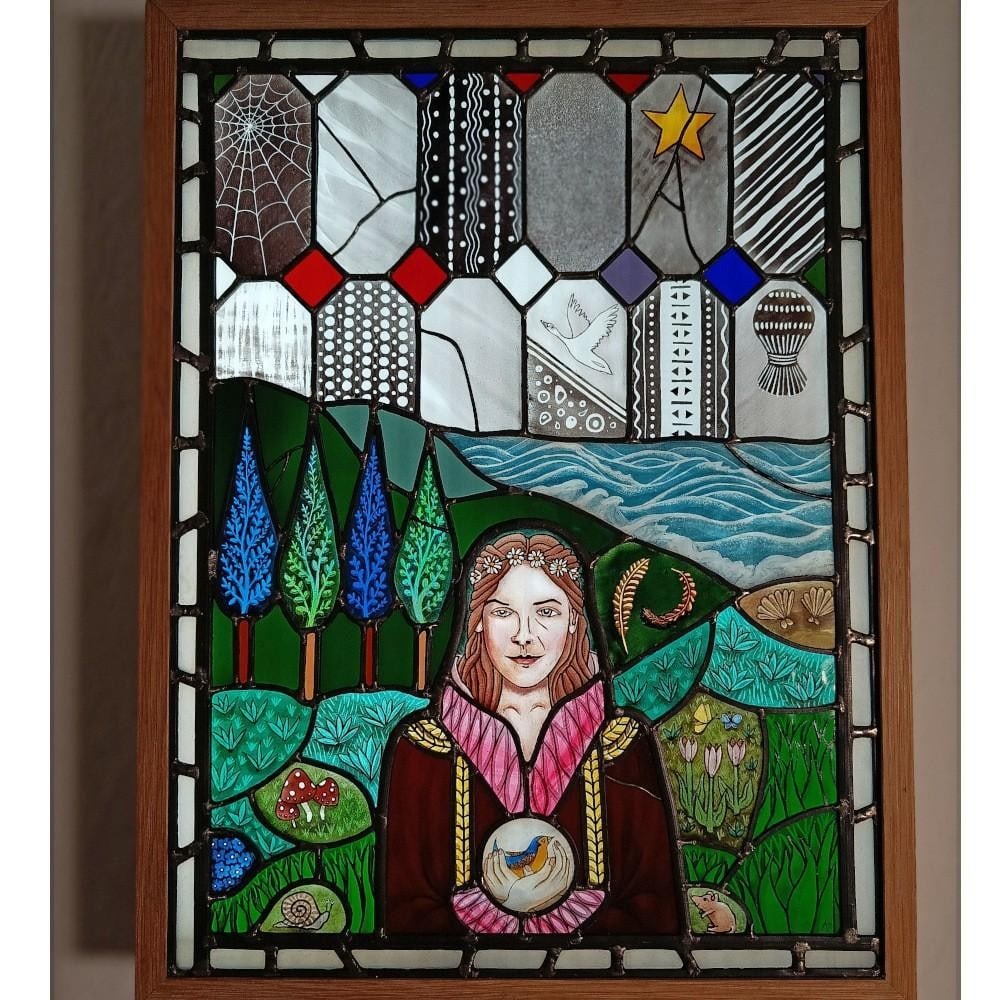 'In Our Hands'' Stained Glass Artwork by April Pebble: ''In Our Hands'' Stained Glass Artwork by April Pebble This stained glass artwork pays tribute to Trena Cox, the renowned Chester-based artist, reimagined for a contemporary context. The piece feature