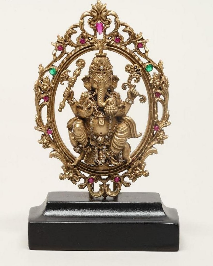 3'' Small Seated Ganesha on Mushak with Wooden Base: 3" Small Seated Ganesha on Mushak with Wooden Base This 3" brass idol depicts Lord Ganesha, the remover of obstacles and deity of wisdom, seated on his vahana, the mouse Mushak, in a blessing ge