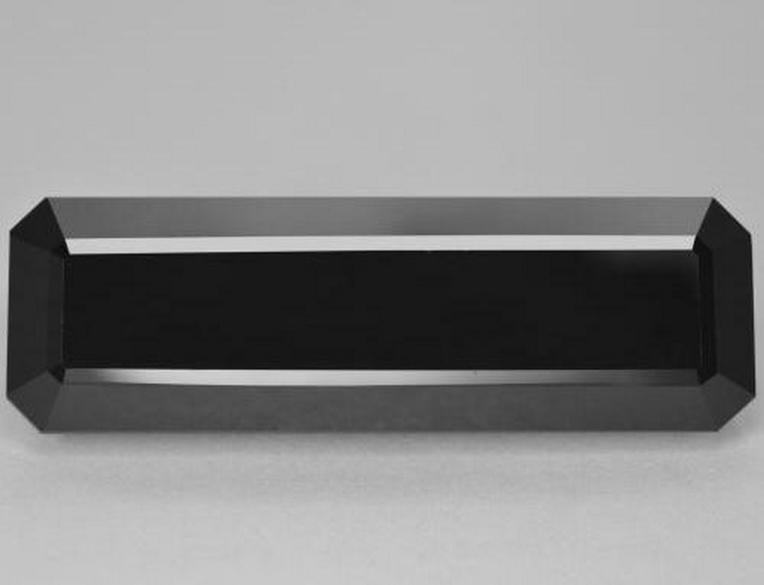 44.07ct Natural Black Tourmaline, Octagon Step Cut, Opaque: 44.07ct Natural Black Tourmaline, Octagon Step Cut, Opaque A striking 44.07-carat natural black tourmaline gemstone, cut in an octagon step shape with an opaque schorl color. Measuring approximately 3