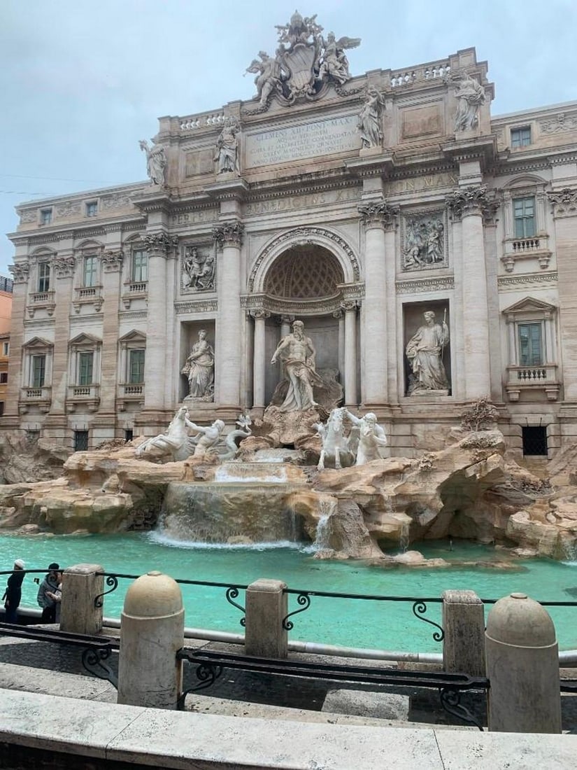Wishes in Motion: Wishes in Motion The Trevi Fountain spills with elegance and energy, its cascading waters glinting under the Roman sun. Marble figures emerge in dramatic motion-Oceanus commanding the waves, tritons