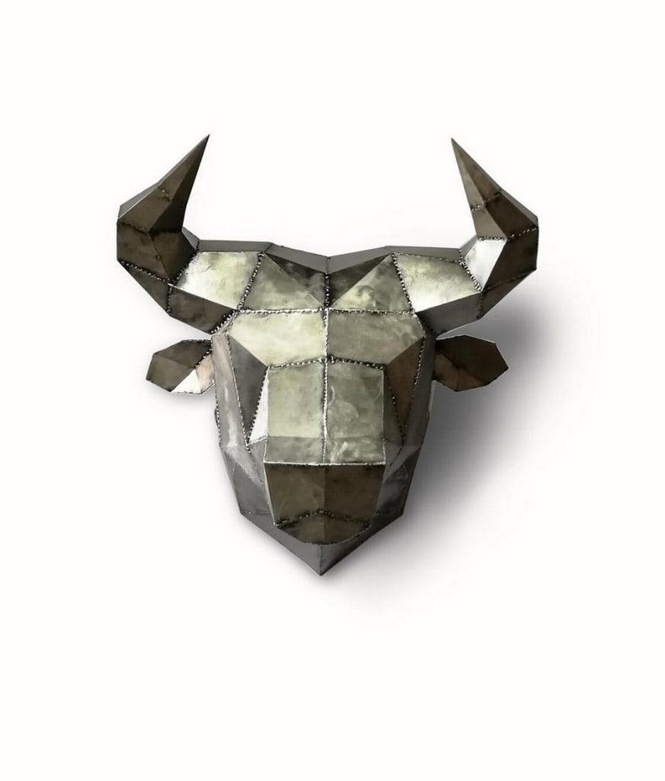 Abstract Metal Bull Head Sculpture: Abstract Metal Bull Head Sculpture This handcrafted metal sculpture depicts the head of a bull, capturing the strength and presence of the animal in a bold, stylized form. Varnished to prevent oxidati
