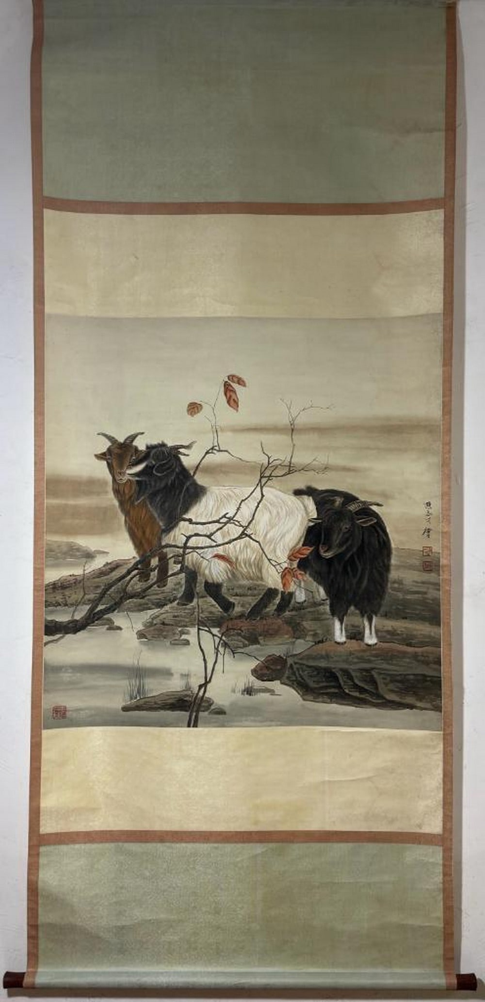 Inspired Handpainted Scroll Three Auspicious Goats by the Water: Inspired Handpainted Scroll Three Auspicious Goats by the Water This elegant scroll painting inspired by Chen Zhicai embodies the traditional auspicious motif Sanyang Kaitai, symbolizing the welcome