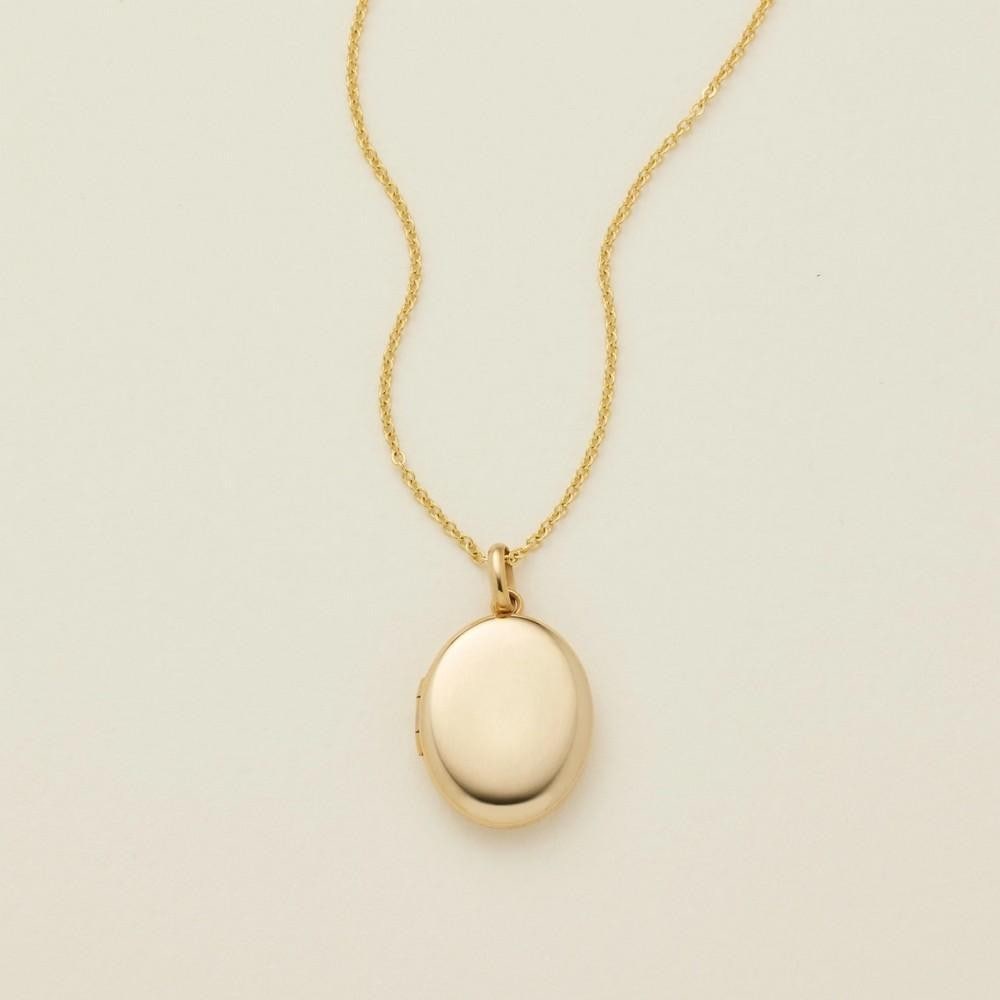 Gold Filled Mini Oval Photo Locket Necklace: Gold Filled Mini Oval Photo Locket Necklace A small oval-shaped locket measuring 14mm by 17mm, designed to hold a photo or keepsake sized 8mm by 11mm. The locket hangs from an adjustable 16" -18