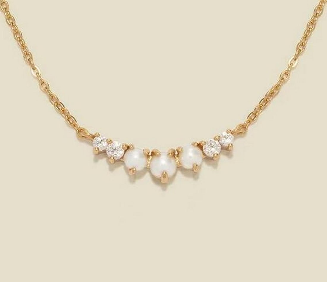 Luminous Crescent Pearl Necklace: Luminous Crescent Pearl Necklace Embrace timeless elegance with this gracefully understated necklace. A fixed crescent of graduated freshwater pearls is beautifully enhanced by the subtle sparkle of