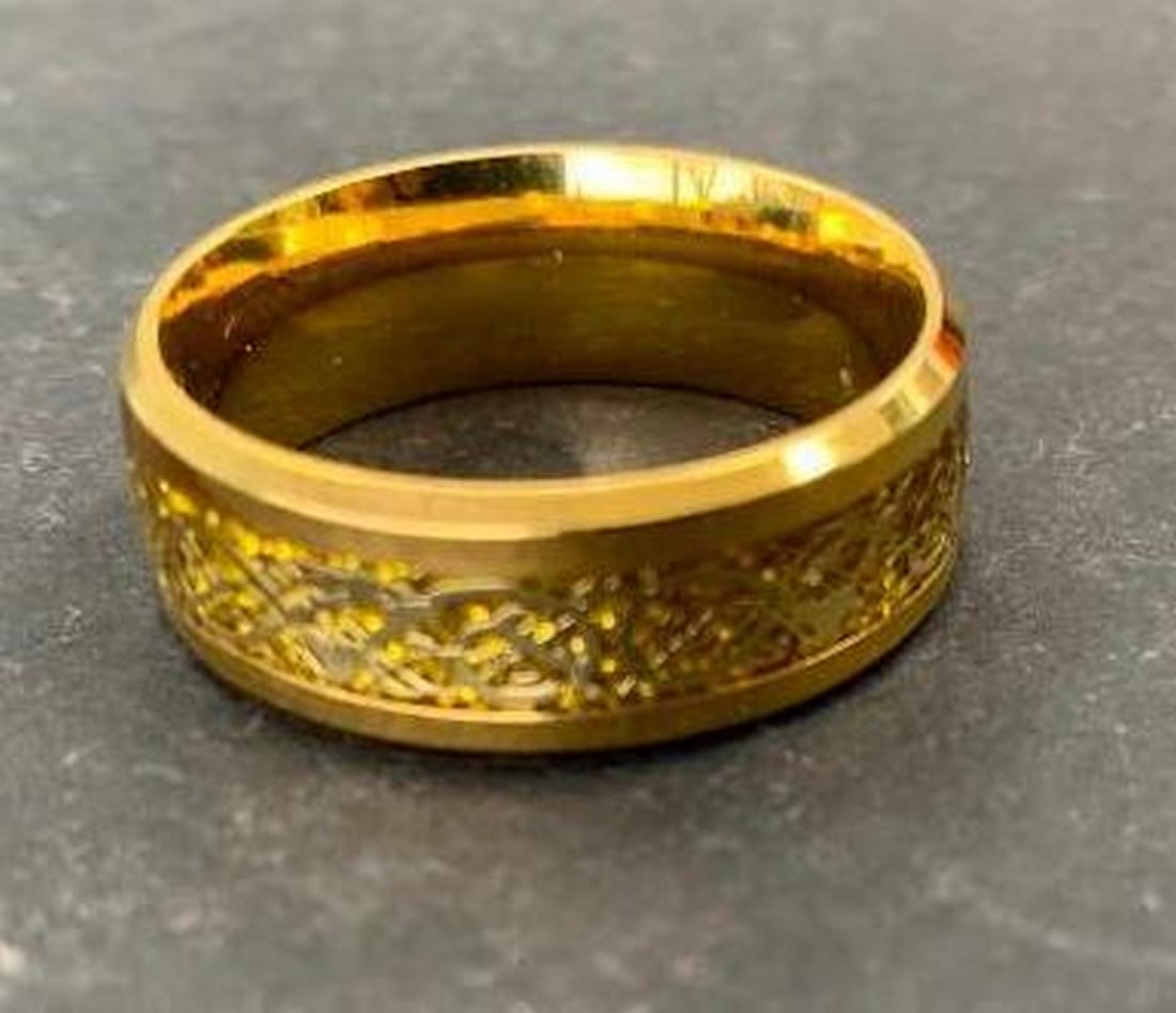 Titanium Ring with Intricate Carved Band: Titanium Ring with Intricate Carved Band Add timeless sophistication to your style with this gold-toned titanium ring, featuring beautifully intricate carvings encircling the middle band. Lightweight,