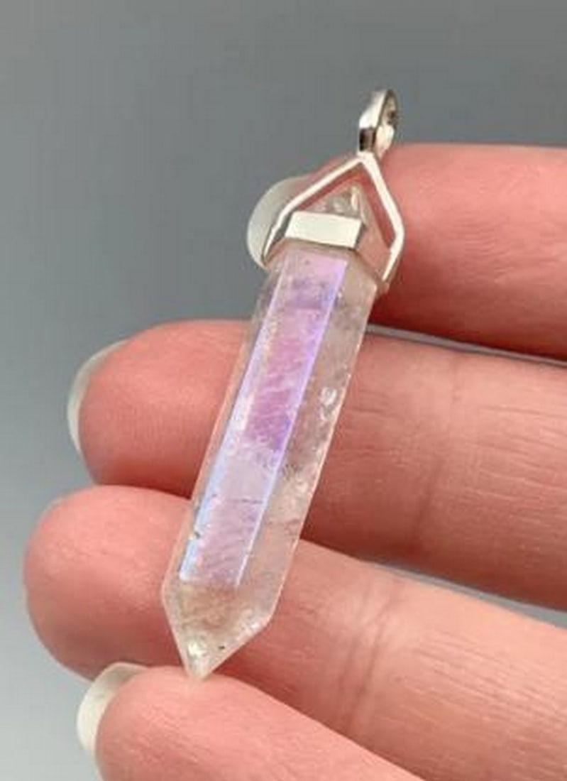 Opalescent Quartz Pendant In Sterling Silver Setting: Opalescent Quartz Pendant In Sterling Silver Setting. Mystical and mesmerizing, this pendant radiates ethereal beauty and powerful energy. The shimmering opalescent quartz displays a soft, iridescent 