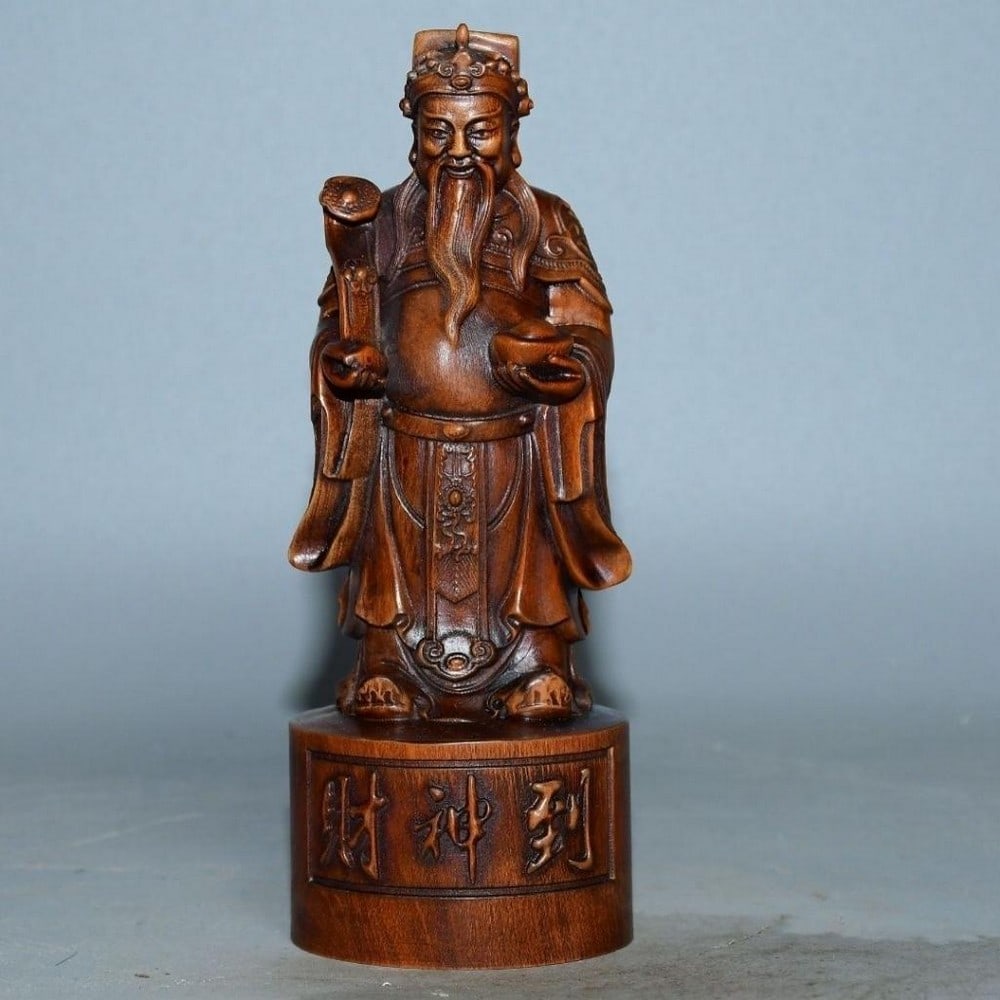Old boxwood carving of the God of Wealth: Old Boxwood Carving of the God of Wealth A powerful wooden statue of the God of Wealth, hand-carved from seasoned wood and rich with symbolic detail. Depicted holding traditional emblems of prosperity