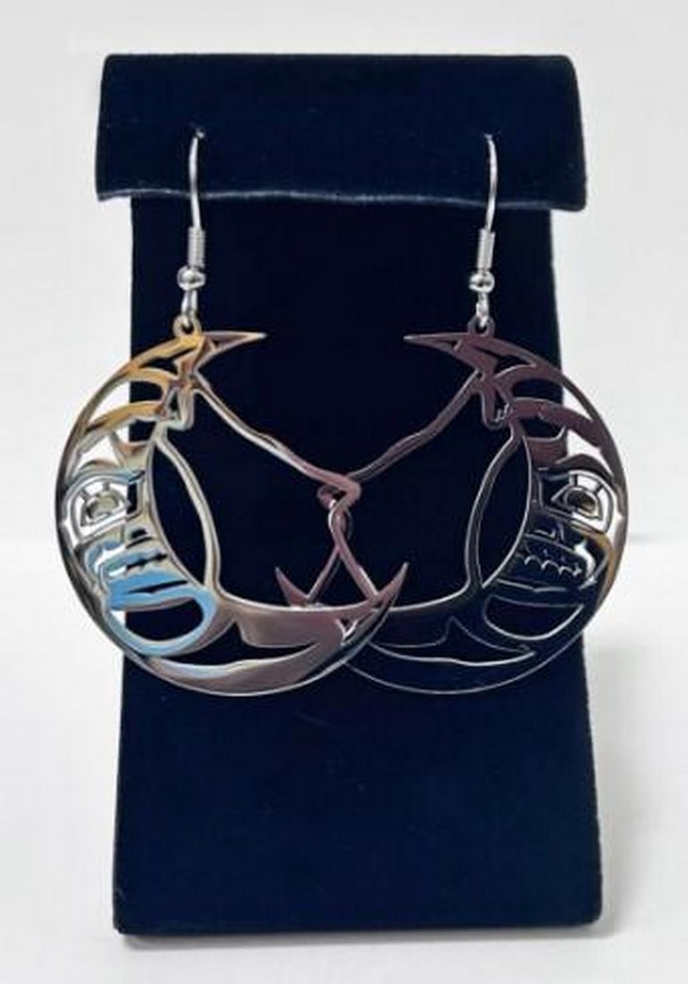 Lunar Howl Earrings: Lunar Howl Earrings The Lunar Howl Earrings capture the mystical connection between the wolf and the moon. Crafted from durable stainless steel, these earrings feature a striking wolf silhouette set