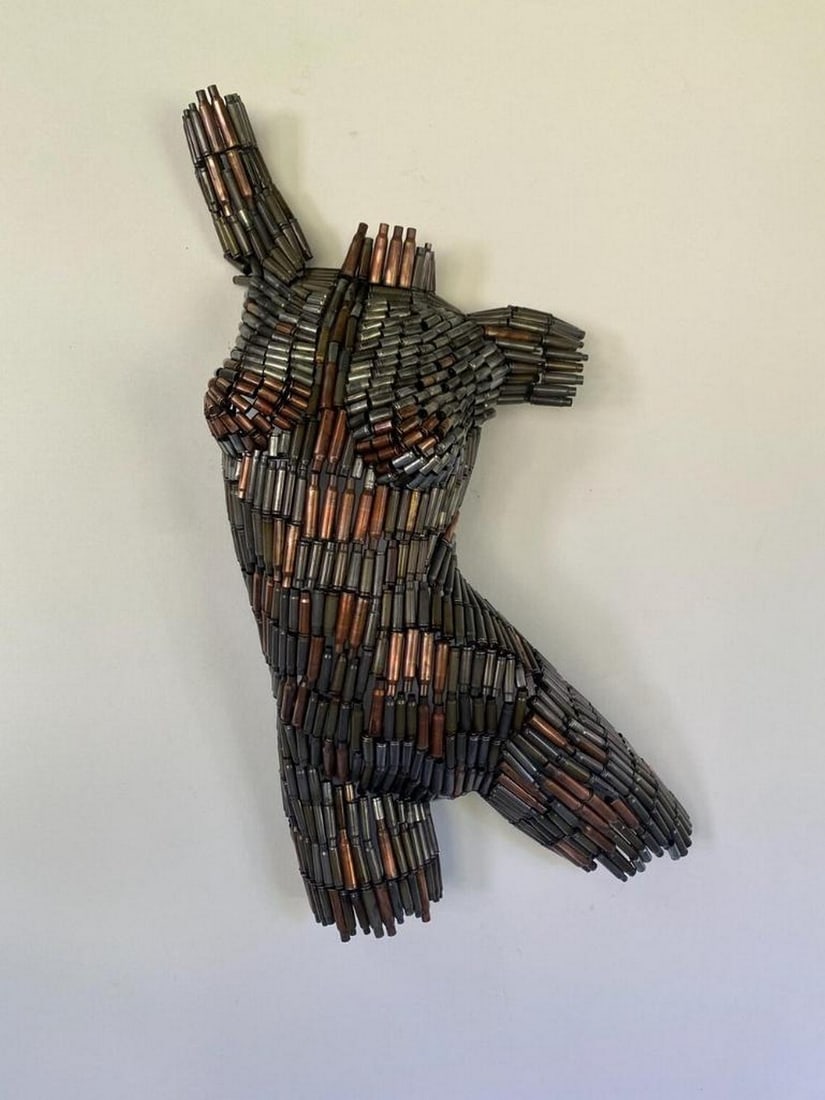Bullet Barbie VIII Metal Sculpture: Bullet Barbie VIII Metal Sculpture A striking fusion of strength and elegance, this captivating female torso is meticulously hand-formed from spent bullet casings and expertly welded together. The int