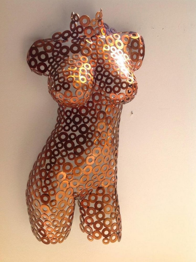 Ember Elegance Metal Sculpture: Ember Elegance Metal Sculpture This striking female torso sculpture captures the essence of movement and form, expertly hand-formed and welded to create a dynamic interplay of light and shadow. The fi