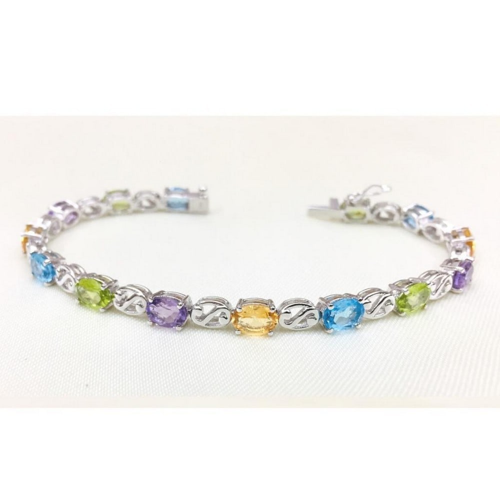 Pastel Stone Studded 925 Sterling Silver Bracelet: Pastel Stone Studded 925 Sterling Silver Bracelet Introducing our " Pastel Stone Studded 925 Sterling Silver Bracelet," a mesmerizing ensemble of serene blue topaz, warm citrine, regal