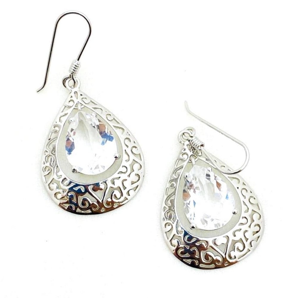 White Quartz Studded Earrings: White Quartz Studded Earrings These 925 Sterling Silver earrings feature a unique design surrounding a white quartz center stone. They have an ear wire backing. View Photos For Further Details.