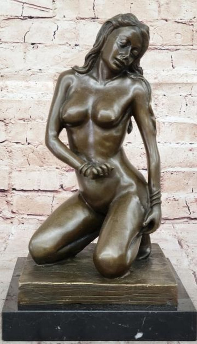 Desire in Bronze Sculpture: Desire in Bronze Sculpture. This captivating bronze sculpture, bearing the signature of artist John Koch, explores the sensuality and beauty of the human form. The piece features a nude figure in a mo