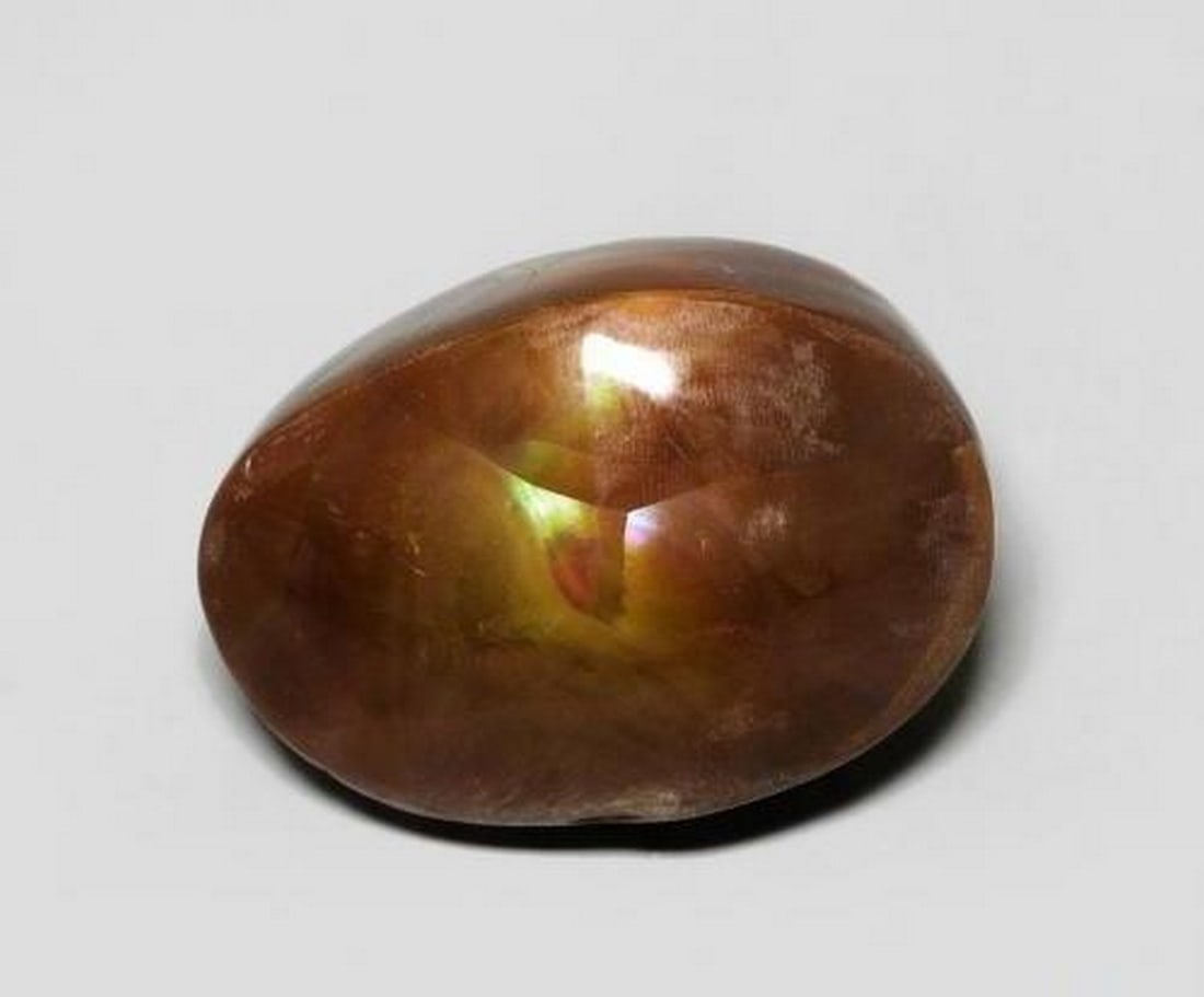 6.64 ct Fancy Multicolor Fire Agate: 6.64 ct Fancy Multicolor Fire Agate Introducing the Fancy Multicolor Fire Agate, a rare natural gemstone weighing 6.64 carats. This Mexican gem features a unique cabochon cut that highlights its vivid