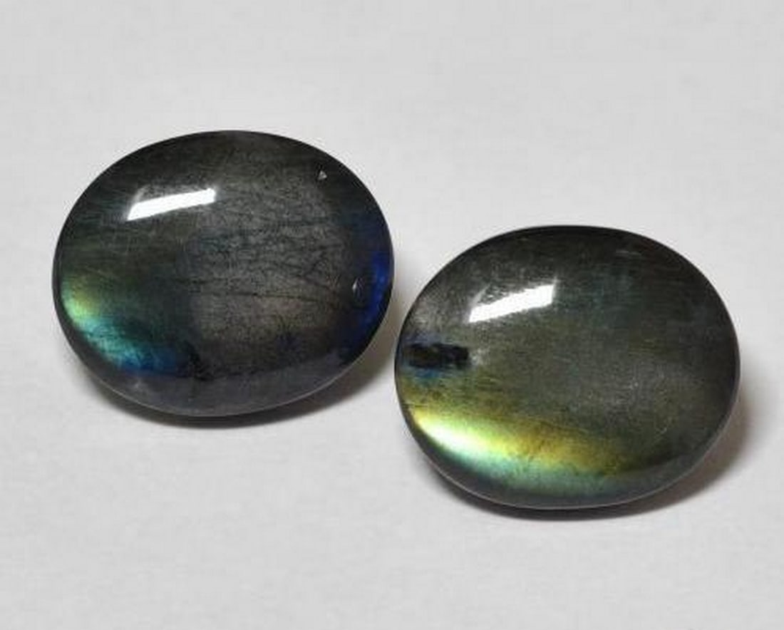 4.09 ct Oval Natural Multicolor Spectrolite Cabochons: 4.09 ct Oval Natural Multicolor Spectrolite Cabochons This matched pair of natural spectrolite gemstones from Finland has a combined total weight of 4.09 carats, averaging approximately 2.05 carats ea