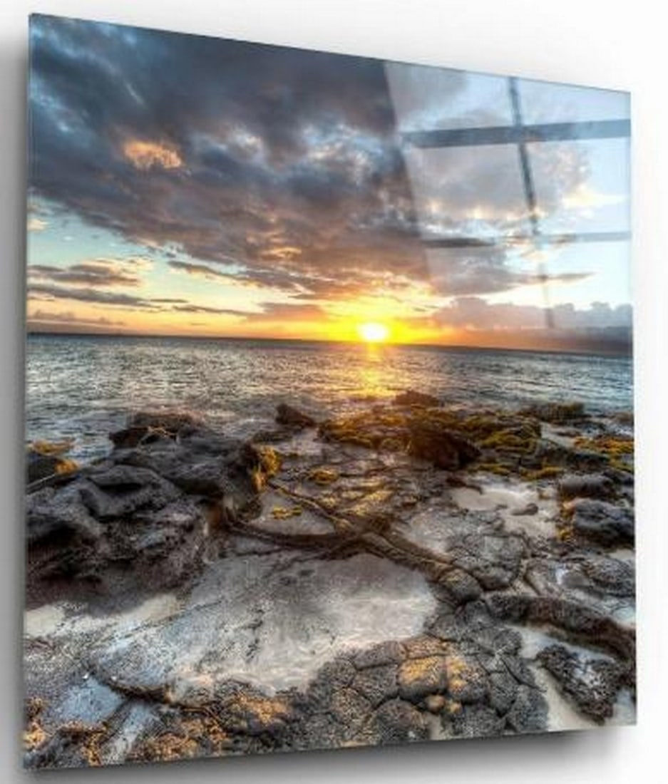 Shoreline Glow Tempered Glass Wall Art: Shoreline Glow Tempered Glass Wall Art Capture the serene beauty of nature with this tempered glass wall art featuring a breathtaking sunset viewed from a rocky beach. The warm hues of the setting sun
