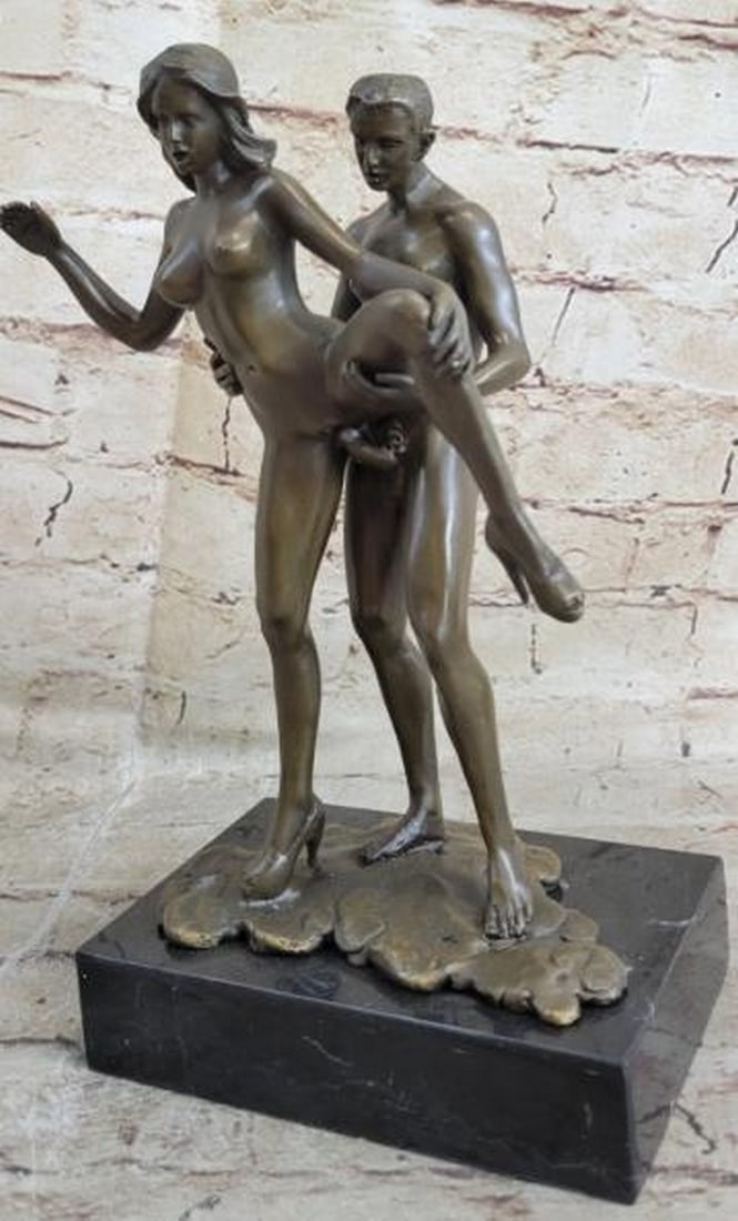 Whispered Embrace Intimate Nude Bronze Sculpture: Whispered Embrace Intimate Nude Bronze Sculpture A tender and passionate portrayal of human connection, this bronze sculpture captures a nude male and female in a deeply intimate moment. Their bodies 