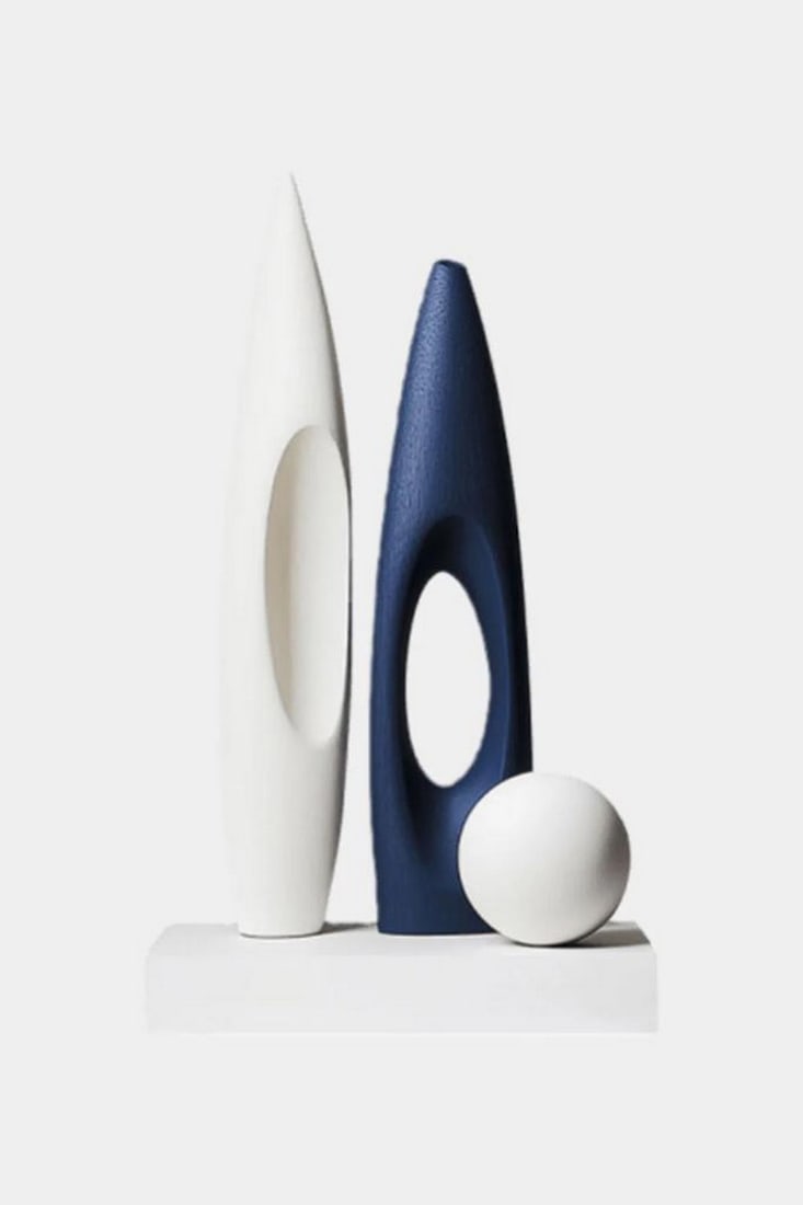 Geometric Oval Trio Sculpture: Geometric Oval Trio Sculpture A contemporary sculpture featuring two elongated oval forms with open centers, paired with a smooth spherical element that adds balance and contrast. The clean lines,