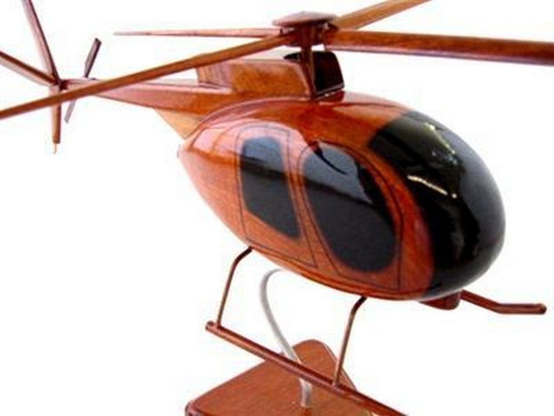 OH-6 LittleBird Helicopter: OH-6 LittleBird Helicopter The classic OH-6 Littlebird helicopter is remarkably replicated in this handcrafted mahogany scale model. Moving rotors, high gloss finish and rich wood grain make this
