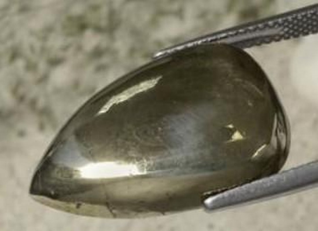 27.11ct Molten Gold Pyrite Pear Gemstone: 27.11ct Molten Gold Pyrite Pear Gemstone This 27.11ct natural pyrite gleams with a rich golden luster, cut into a bold pear shape that highlights its metallic sheen and distinctive character. With