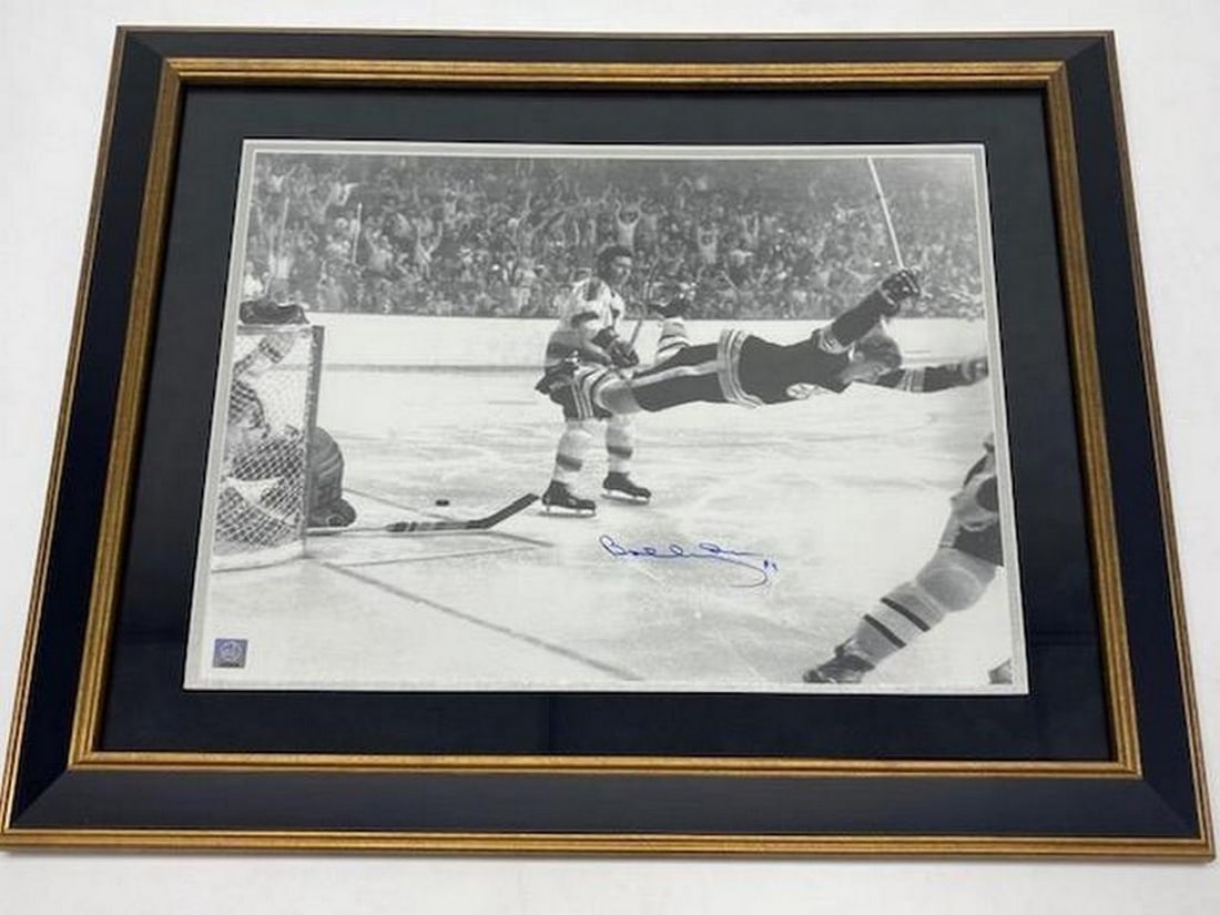 Authentic Bobby Orr ''The Flying Goal'' Autographed Picture With COA From GWN: An Authentic Bobby Orr 20" x 24" - "The Flying Goal" - Autographed Picture With COA From GWN. Picture Is Custom Framed With Ultra Suede Matting. This Is A Premium Framing Package The T