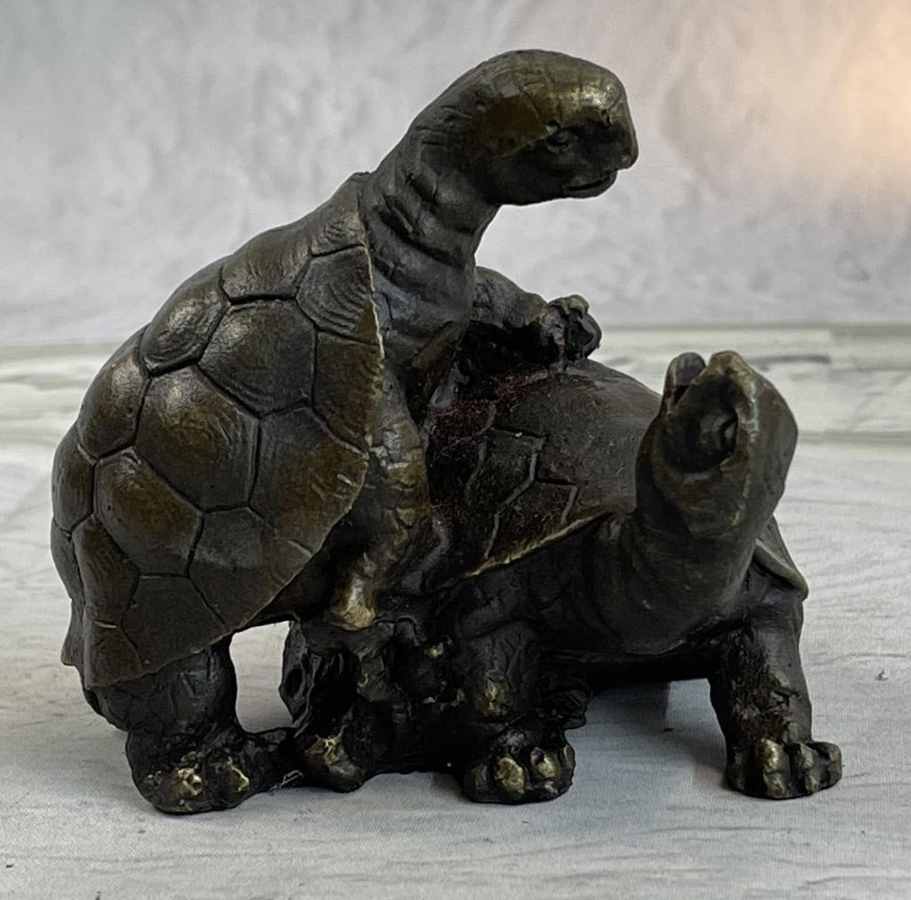 Turtles Sharing Love Bronze Sculpture: Turtles Sharing Love Bronze Sculpture This adorable figurine features an adorable representation of two turtles sharing a loving moment. The first turtle is crawling on top of the second one as the se