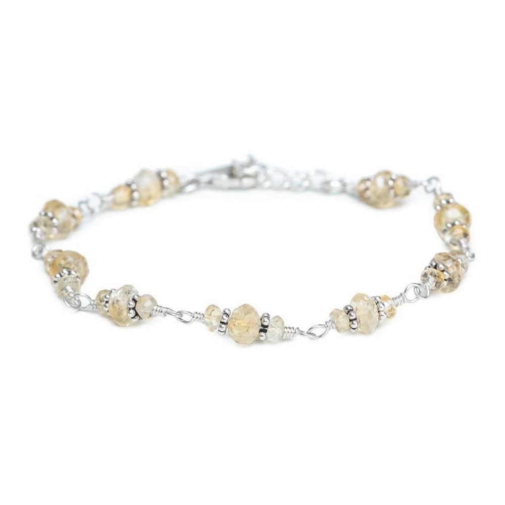 Sterling Silver Bracelet Accented with Citrine Stones: Sterling Silver Bracelet Accented with Citrine Stones This elegant sterling silver bracelet features beautifully faceted citrine stones, each capturing light with a warm, honey-like glow. Known for