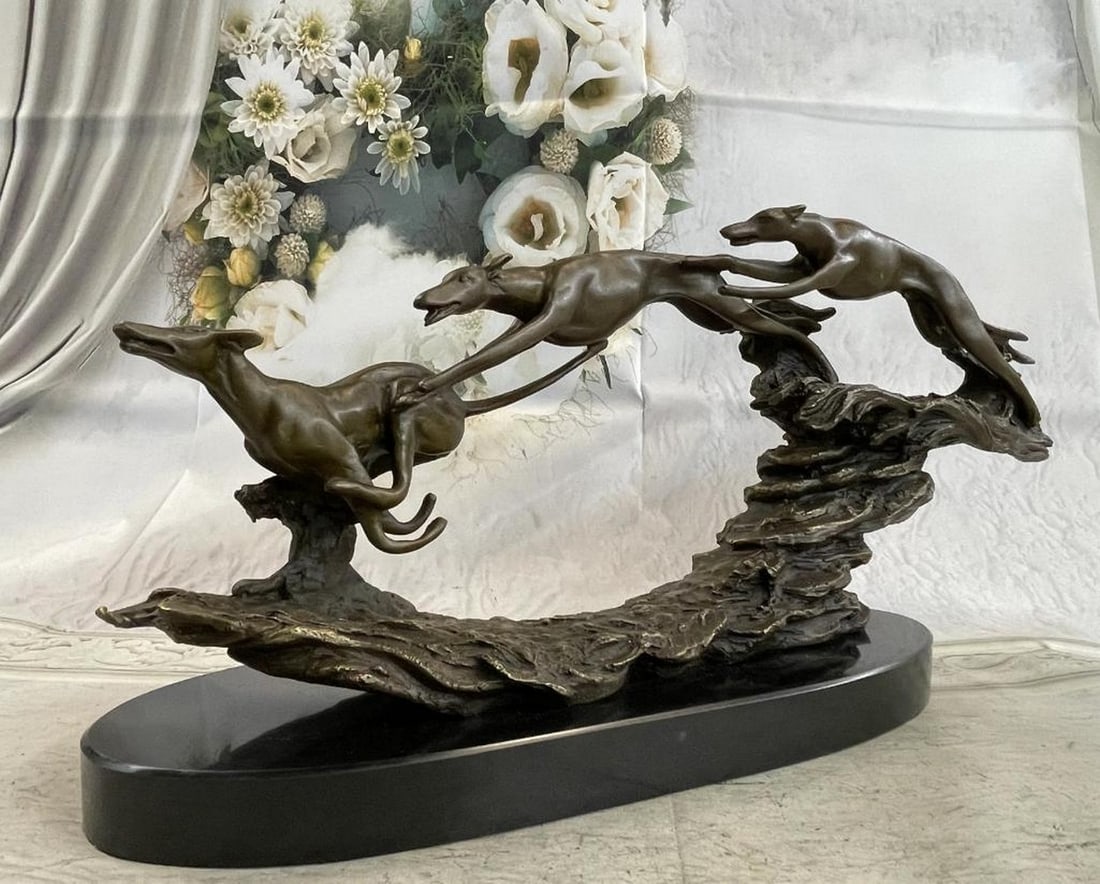 Wild Dogs Running Bronze Sculpture: Wild Dogs Running Bronze Sculpture Three wild dogs run fast through the woods. Their only concern it what lies before them. The first dog had the lead but is beginning to lose speed as the second and 