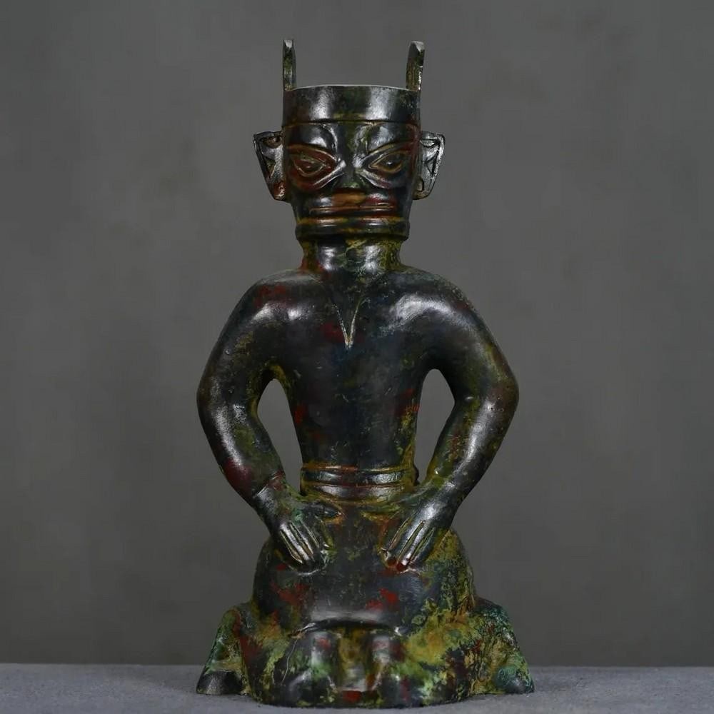 Antique Chinese Bronze Sanxingdui Kneeling Figure Ornament: Antique Chinese Bronze Sanxingdui Kneeling Figure Ornament This rare handcrafted bronze statue depicts a kneeling figure in the distinctive Sanxingdui style, showcasing the mysterious and captivating 