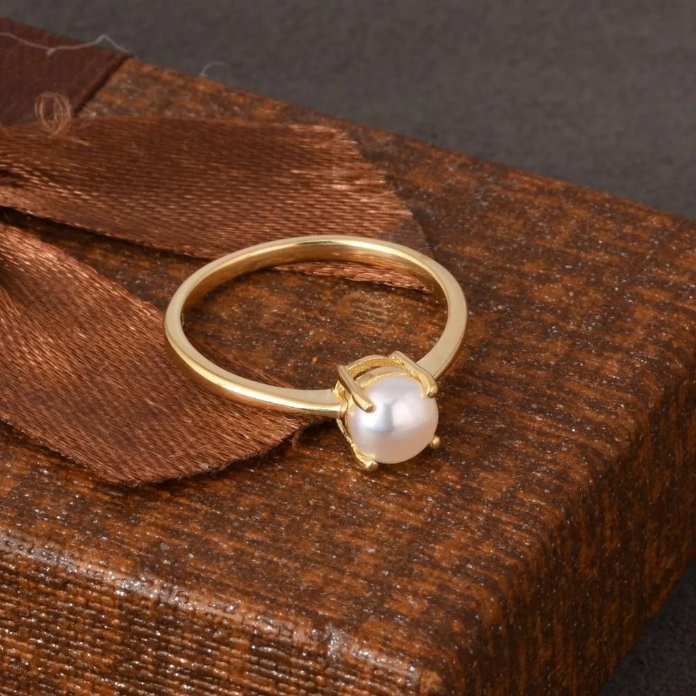 Minimalist Round Pearl Ring Yellow Gold Plated: Minimalist Round Pearl Ring Yellow Gold Plated Elegant and timeless, this round pearl ring features a luminous centerpiece set in yellow gold plating. A perfect gift for any occasion. Size: 8 View pho