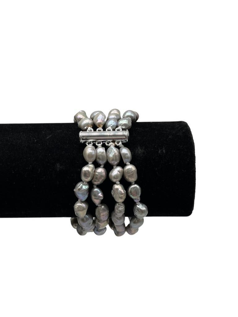 Genuine Silver Luster 5mm-6mm Freshwater 4 Strand Pearl Bracelet: Genuine Silver Luster 5mm-6mm Freshwater 4 Strand Pearl Bracelet.Natural Silver Glimmers Come Off Each Of THe 7-8mm Pearls. There are 60+ Pearls On This 4 Strand Bracelet and Is Accompanied By A Pu