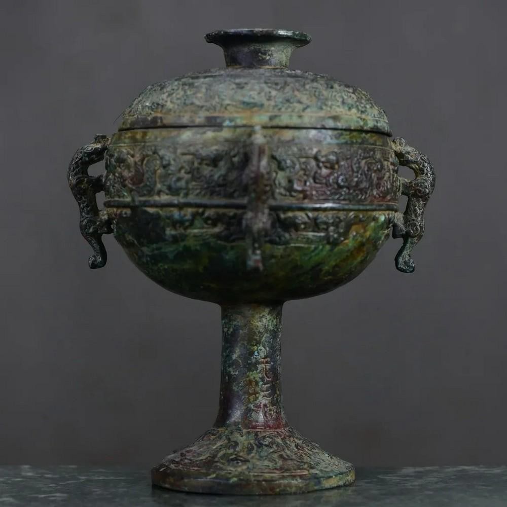 Antique Chinese Dragon Designed Goblet Ornament: Antique Chinese Dragon Designed Goblet Ornament This antique Chinese bronze goblet ornament features an intricate dragon design, symbolizing power, strength, and good fortune. The detailed craftsmansh