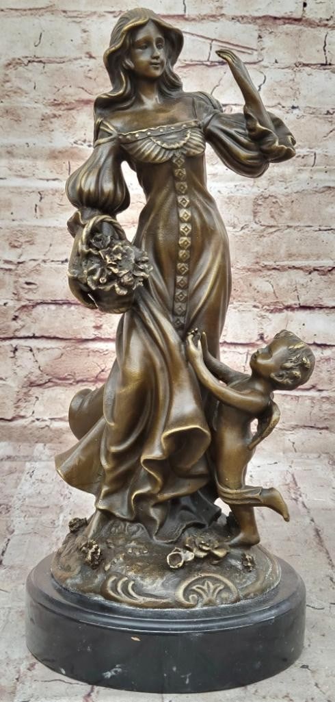 Women Standing with Winged Cherub - 15'' x 6.5'': Women Standing with Winged Cherub - 15" x 6.5" This enchanting sculpture features a beautiful young woman resting by a meadow, accompanied by a baby angel who adores her. He stands beside her, h