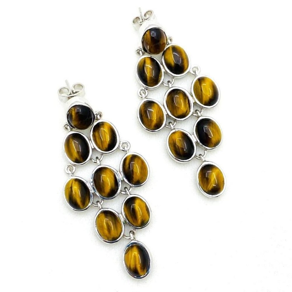Tiger's Eye Cabochon Oval Grate Earrings: Tiger's Eye Cabochon Oval Grate Earrings These unique 925 Sterling Silver earrings have 9 gorgeous brown tiger eye gems on each one arranged in a diamond pattern. View Photos For Further Details.