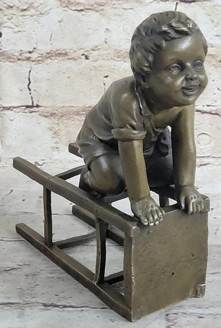 J. Clara Inspired Playful Boy with Stool Bronze Sculpture - 7" x 6": J. Clara Inspired Playful Boy with Stool Bronze Sculpture - 7" x 6" This bronze sculpture depicts a young boy seated on his knees beside an overturned stool, holding onto it with both hands. T