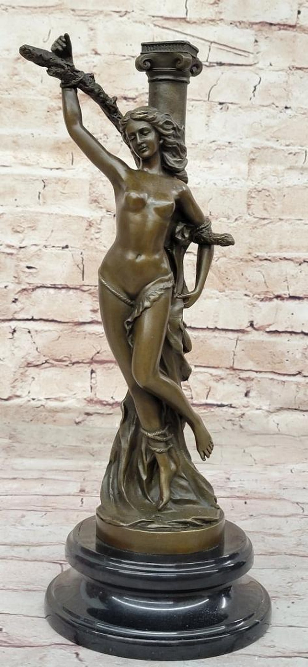 Captured Nymph Inspired Bronze Statue - 14" x 5.5": Captured Nymph Inspired Bronze Statue - 14" x 5.5" This evocative bronze sculpture portrays a bound nude nymph, standing atop a rock with her wrist and arm tied to a pole. Despite her captivit
