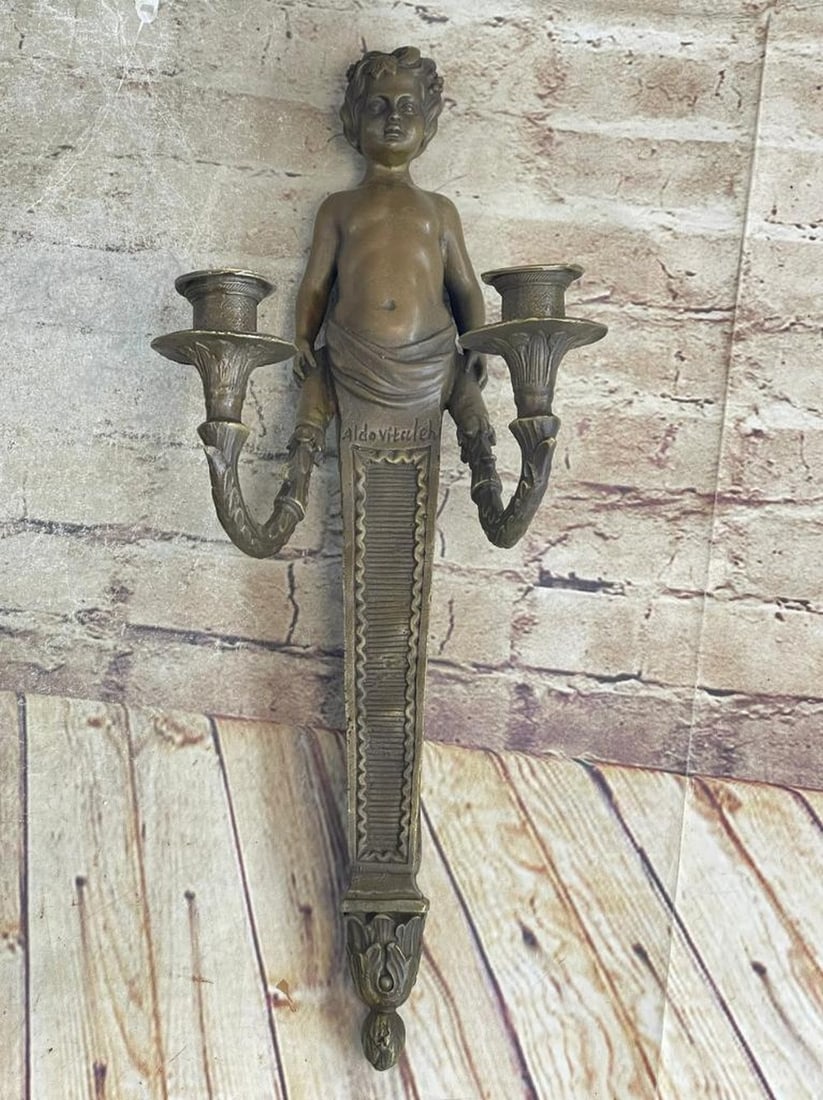 Signed Original Cherub Boy Wall Candle Holder Bronze Sculpture - 17.5" x 5": Signed Original Cherub Boy Wall Candle Holder Bronze Sculpture - 17.5" x 5" A young boy is the focal point of this fascinating wall candle holder. His kegs curve and transform into a U shaped,
