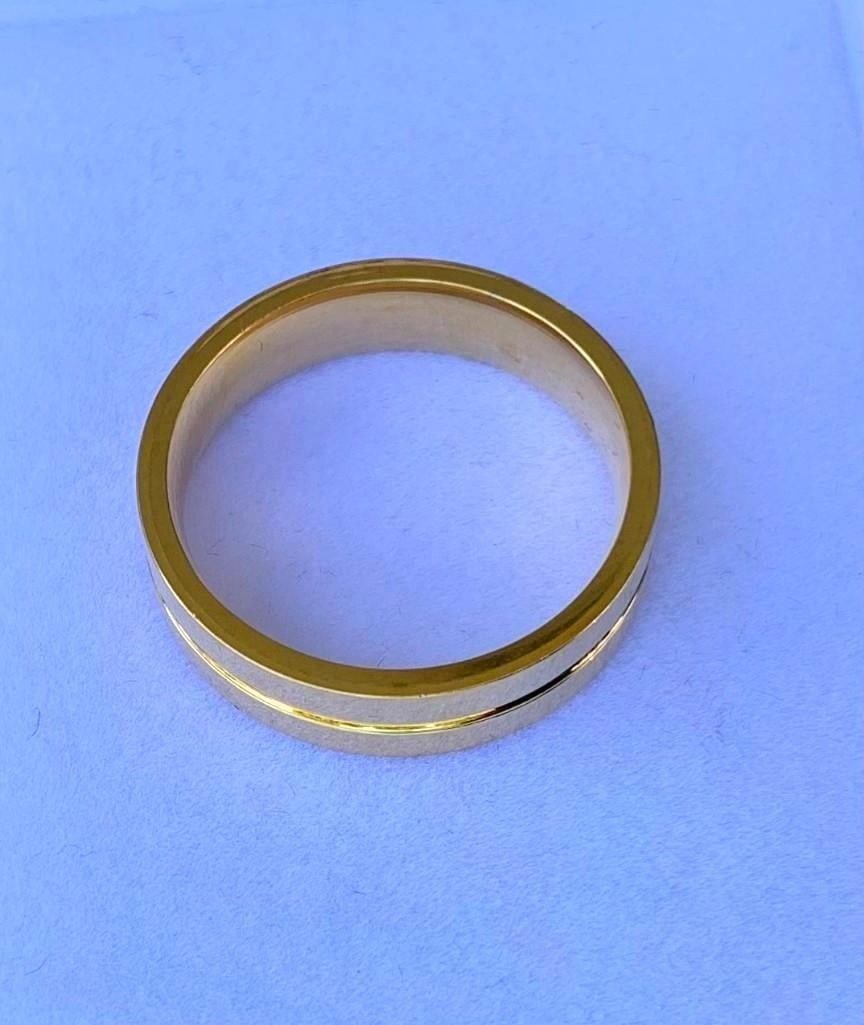 Men's Gold-Colored Stainless Steel Ring: Men s Gold-Colored Stainless Steel Ring This sleek men s ring combines elegance and durability, crafted from stainless steel. The band features a subtle yet striking carved line running around the
