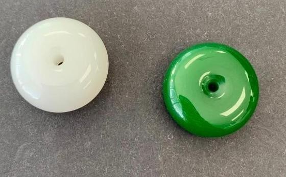 Jade Beads with Polished Finish: Jade Beads with Polished Finish A pair of elegant round beads featuring a smooth, glossy surface and central hole-ideal for stringing or crafting. One bead is a classic white, while the other