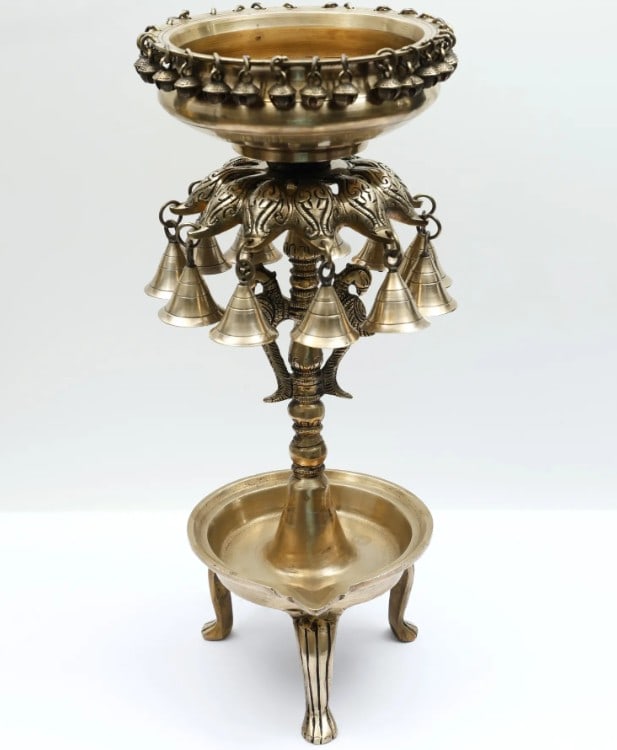 18'' Designer Brass Urli with Bells and Diya - Traditional Elegance for Festive Decor: 18" Designer Brass Urli with Bells and Diya - Traditional Elegance for Festive Decor This 18" Designer Brass Urli is a stunning embodiment of traditional Indian craftsmanship paired with contemp