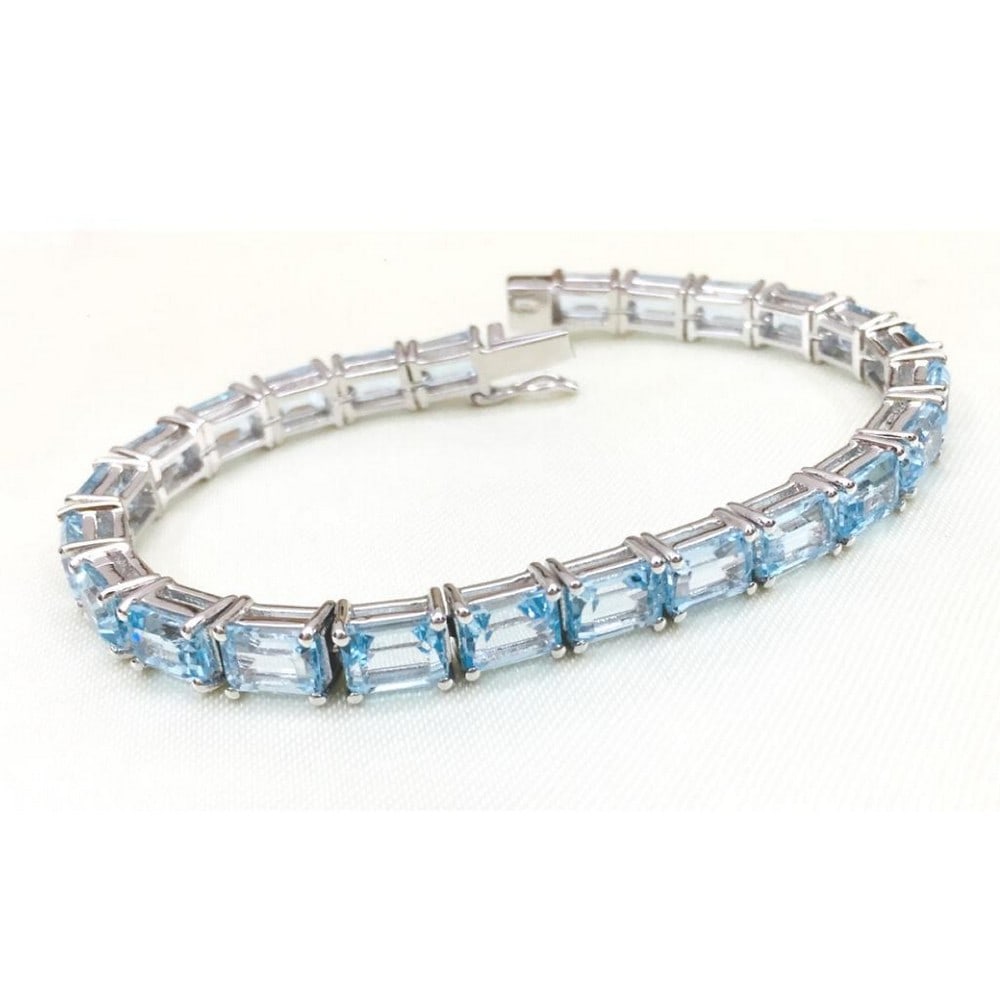 Blue Topaz Studded Bracelet: Blue Topaz Studded Bracelet This 925 Sterling Silver bracelet features blue topaz retangle faceted stones. Gemstone Size: 7x5mm View Photos For Further Details.