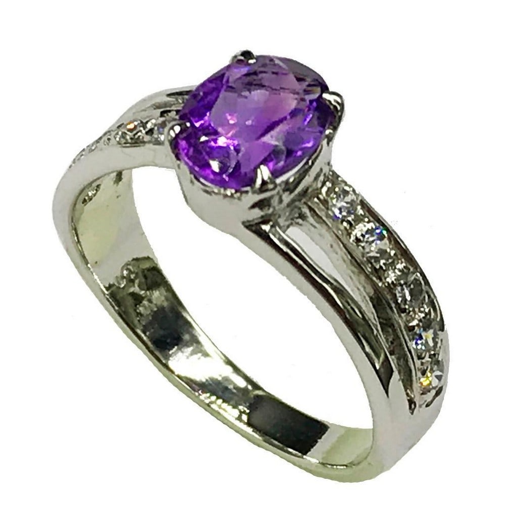 Sterling Silver Amethyst Stone Ring: Sterling Silver Amethyst Stone Ring This ring is studded with zirconias and a beautiful amethyst gemstone. Inner Diameter: 17.75mm View Photos For Further Details