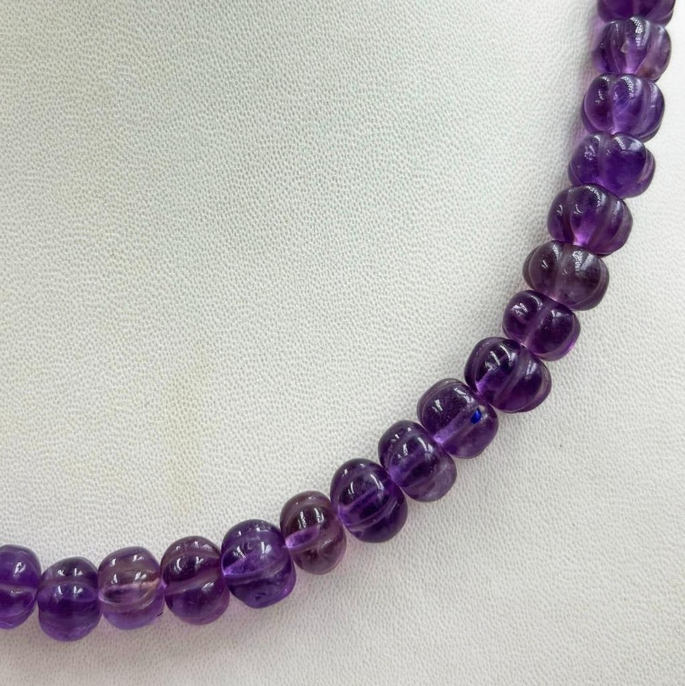 16.5" Watermelon Shaped Amethyst Beads String Necklace: 16.5" Watermelon Shaped Amethyst Beads String Necklace Introducing our 16.5" Watermelon-Shaped Amethyst Beads String Necklace, a playful and eye-catching accessory that combines the